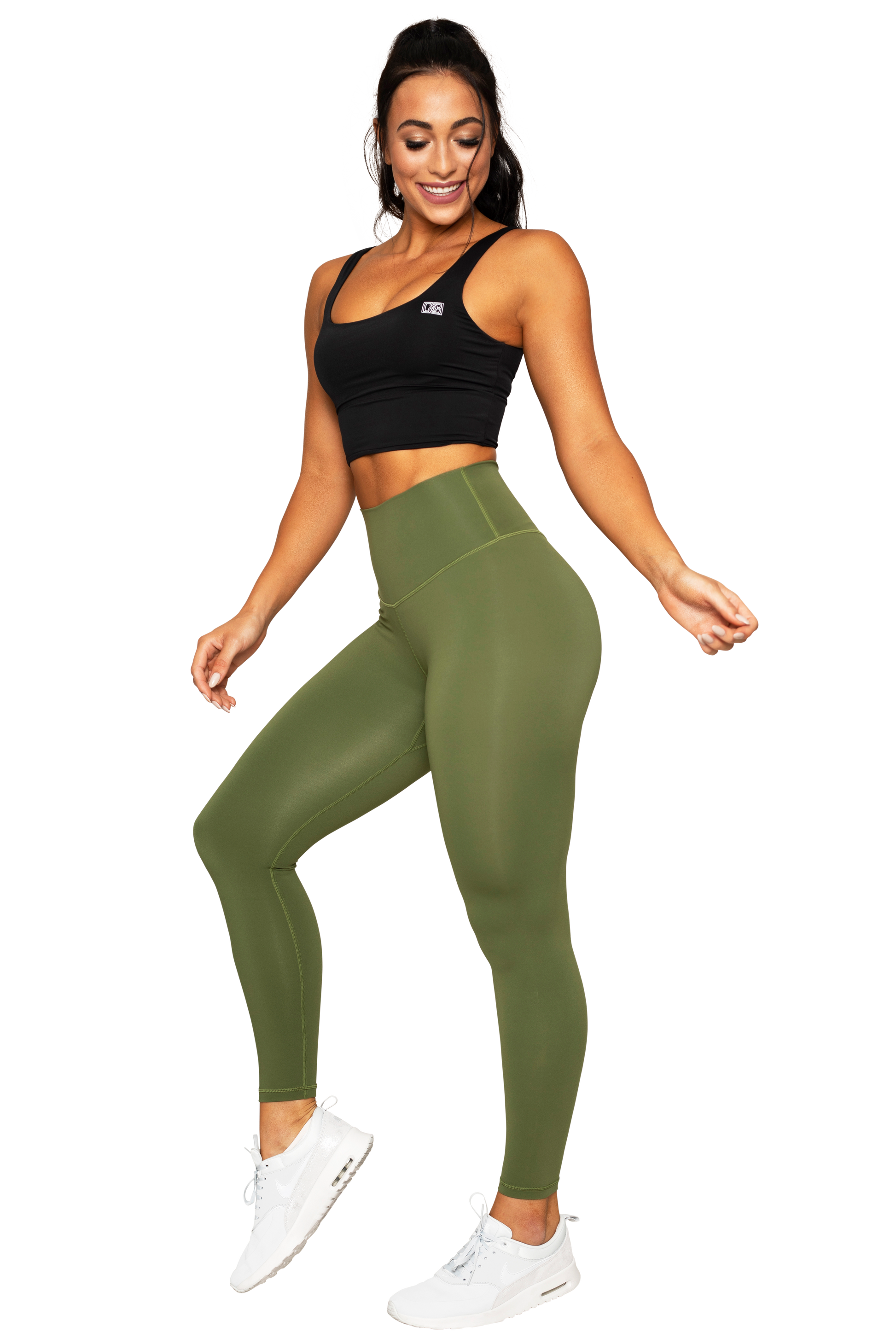 Slim motivated brunette woman dressed in cropped top and leggings, has  workout with dumbbells, poses on green lawn near private house, has perfect body  shape. Healthy lifestyle and sport concept 14939965 Stock